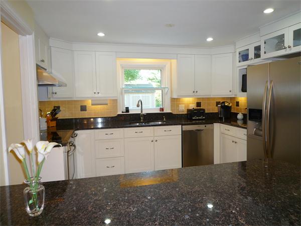 9 Bridge Street Lexington, MA 02421 - Photo 8 of 20 a kitchen with granite countertop a refrigerator sink and white cabinets