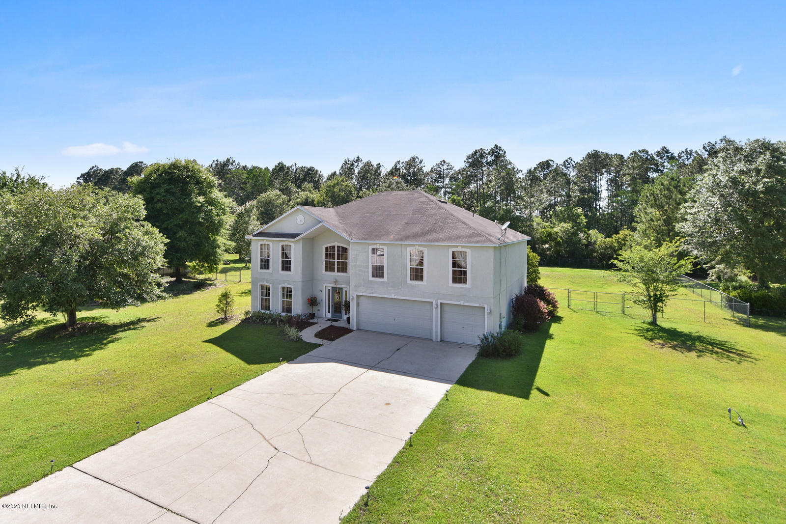 55371 Bear Run Road Callahan, FL 32011 - Photo 1 of 29 a aerial view of a house next to a big yard and large trees