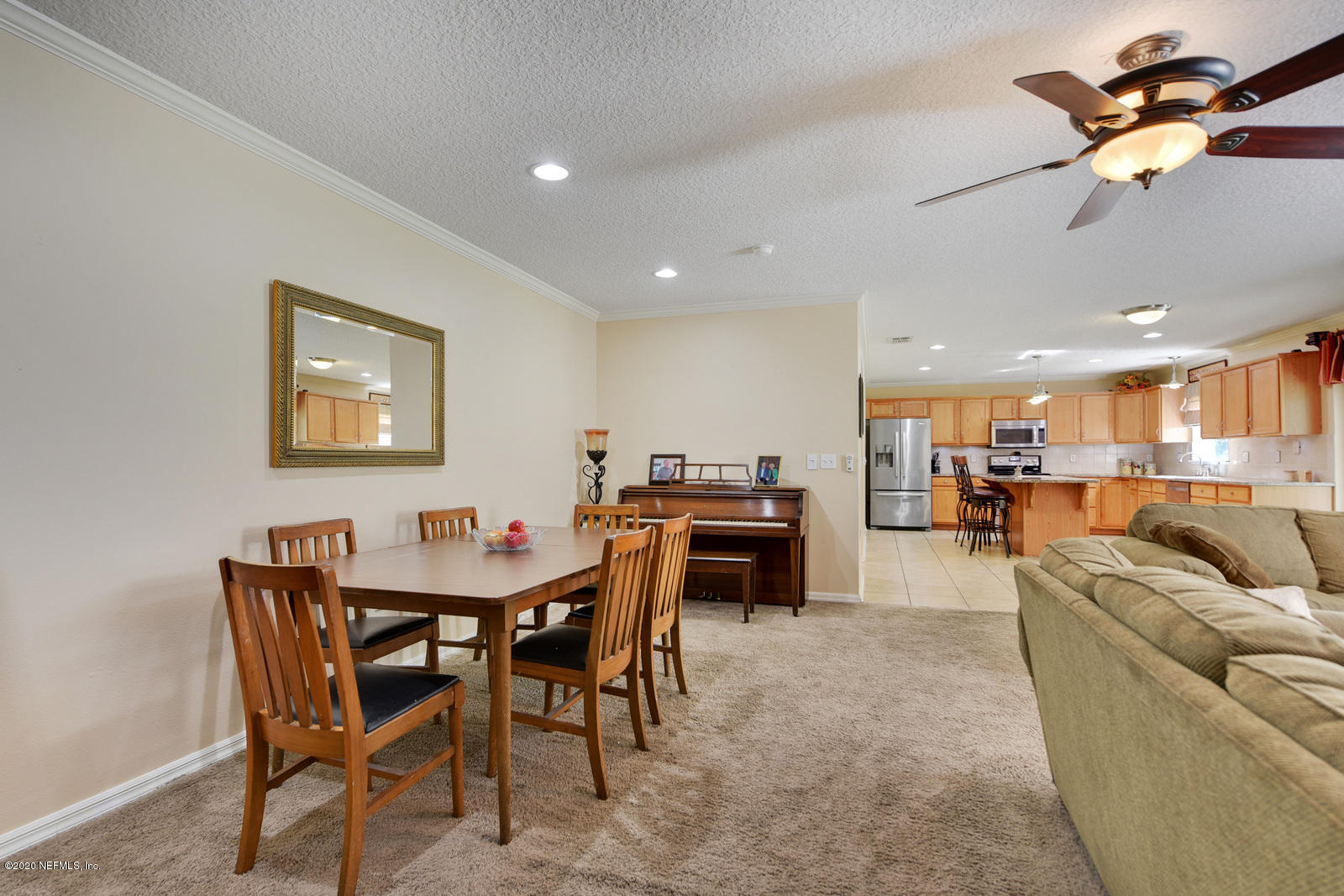 55371 Bear Run Road Callahan, FL 32011 - Photo 12 of 29 a living room with furniture a table and kitchen view