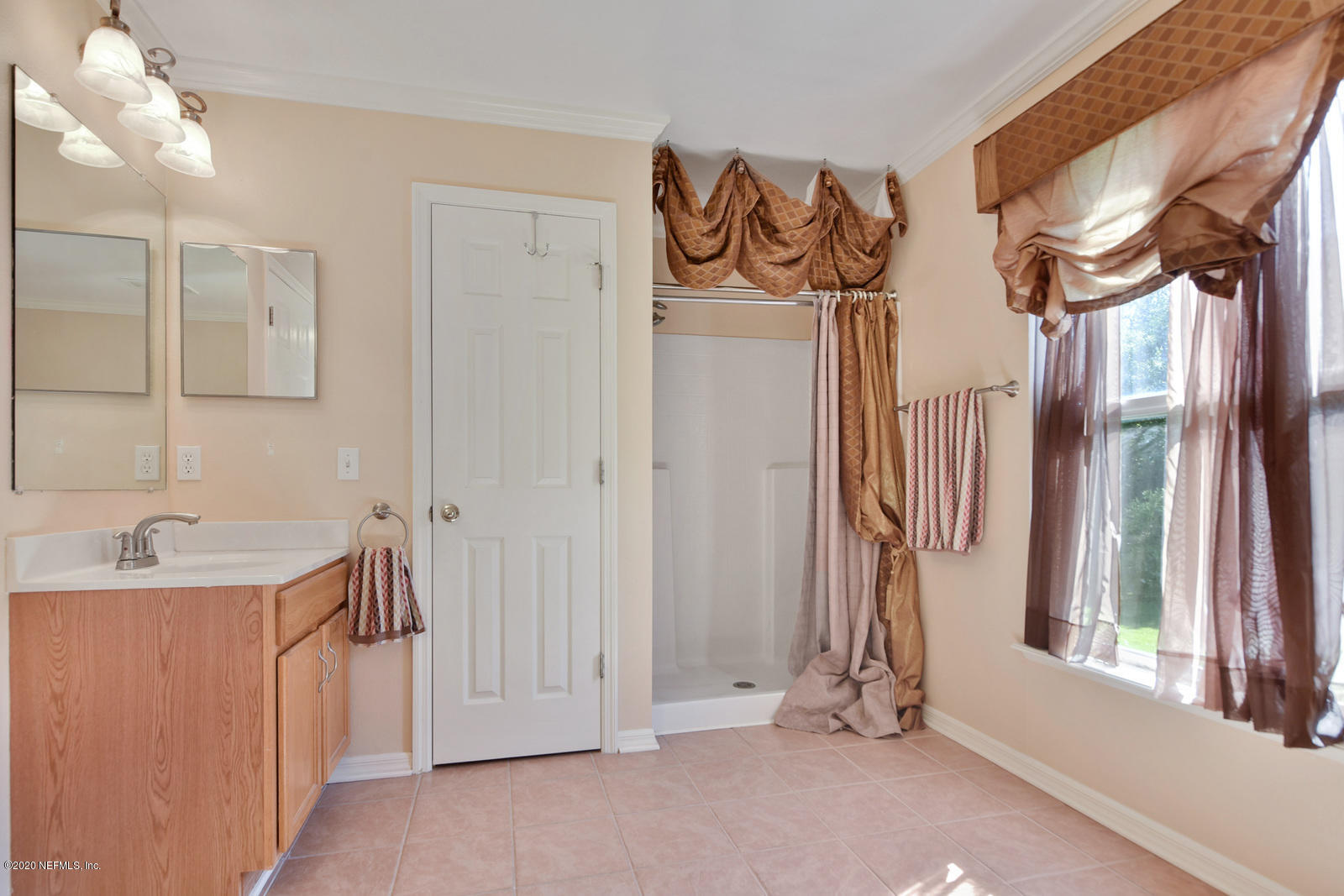 55371 Bear Run Road Callahan, FL 32011 - Photo 20 of 29 a view of a bathroom with a sink and mirror with window