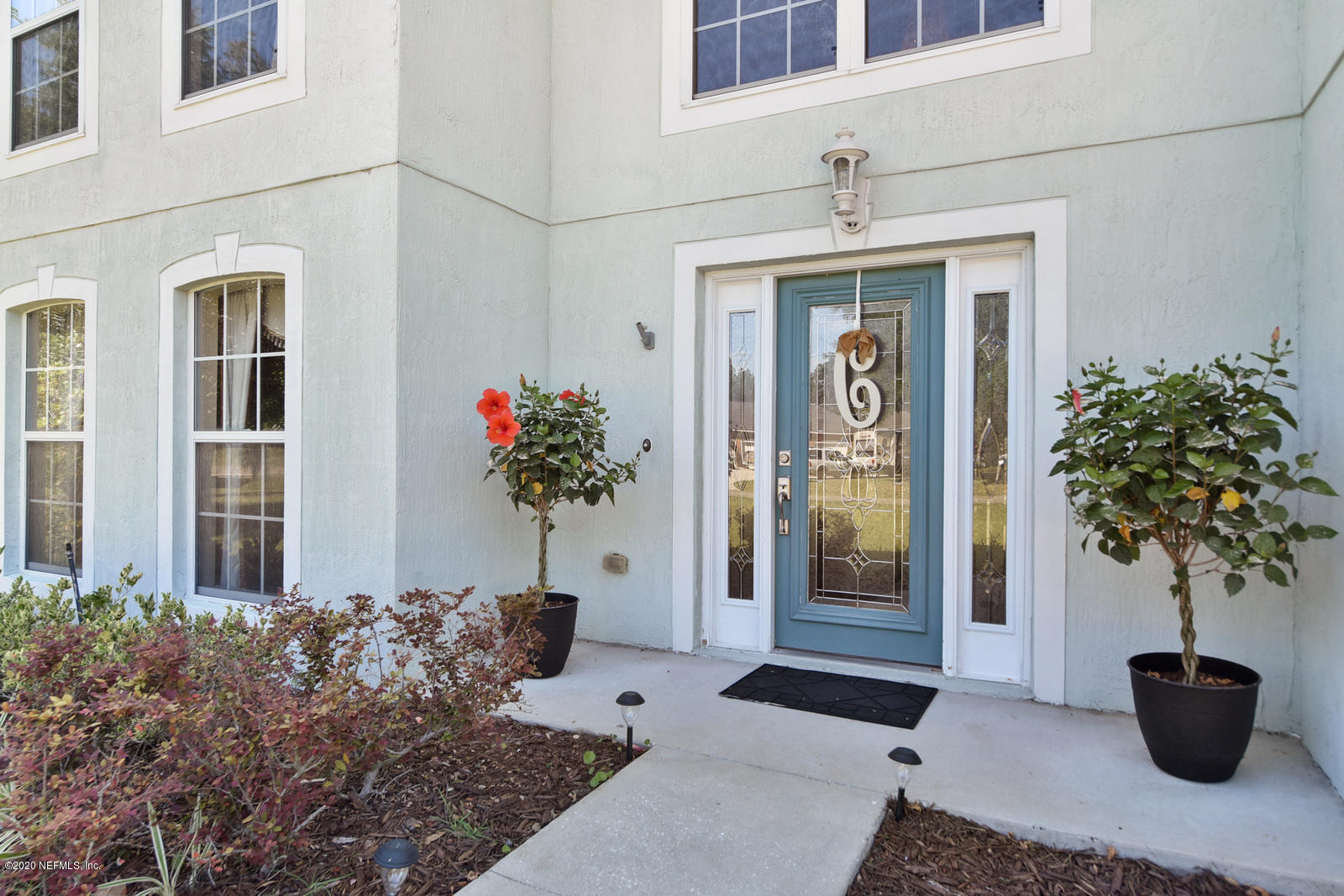 55371 Bear Run Road Callahan, FL 32011 - Photo 3 of 29 a front view of a house with patio