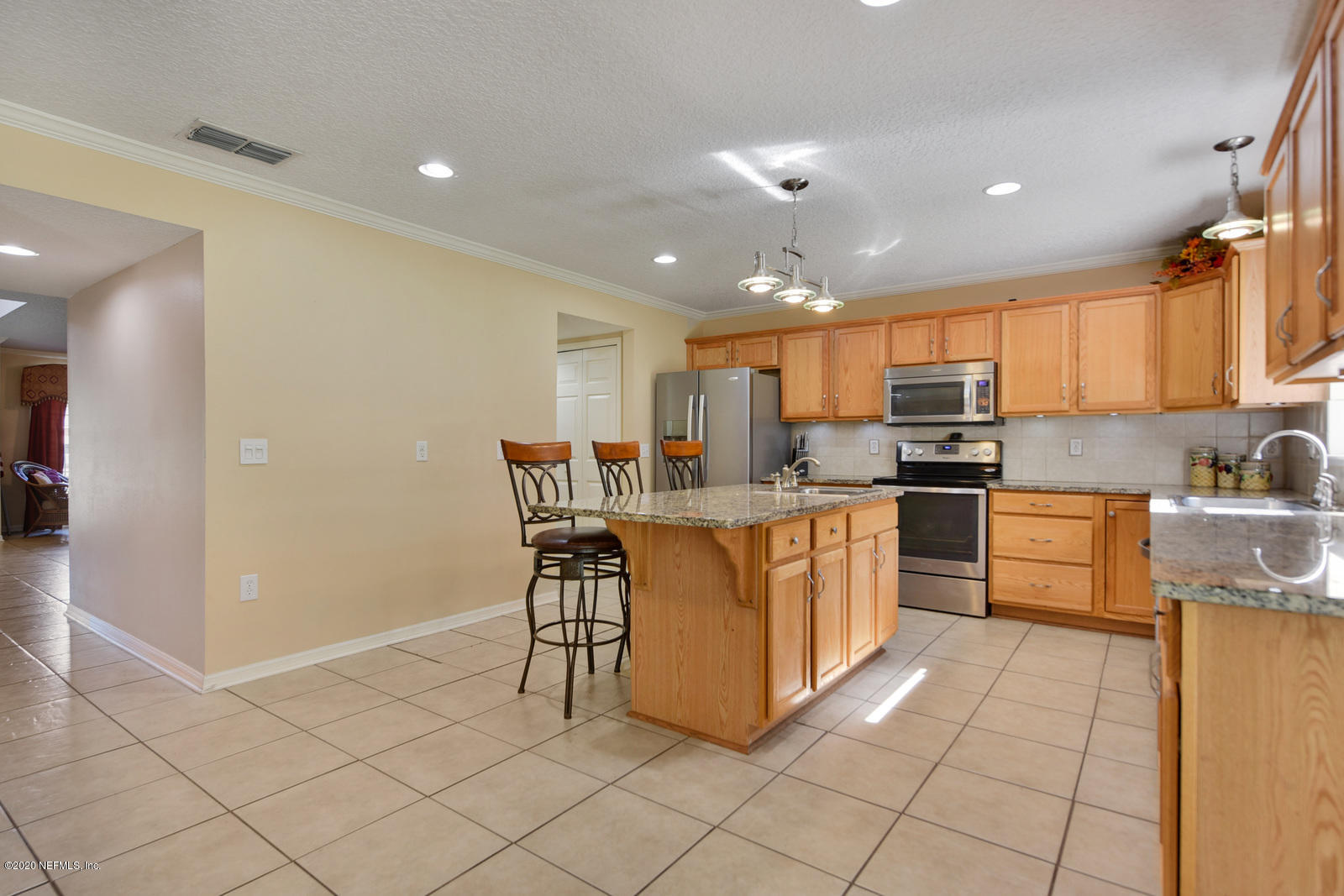 55371 Bear Run Road Callahan, FL 32011 - Photo 7 of 29 a kitchen with cabinets and chairs