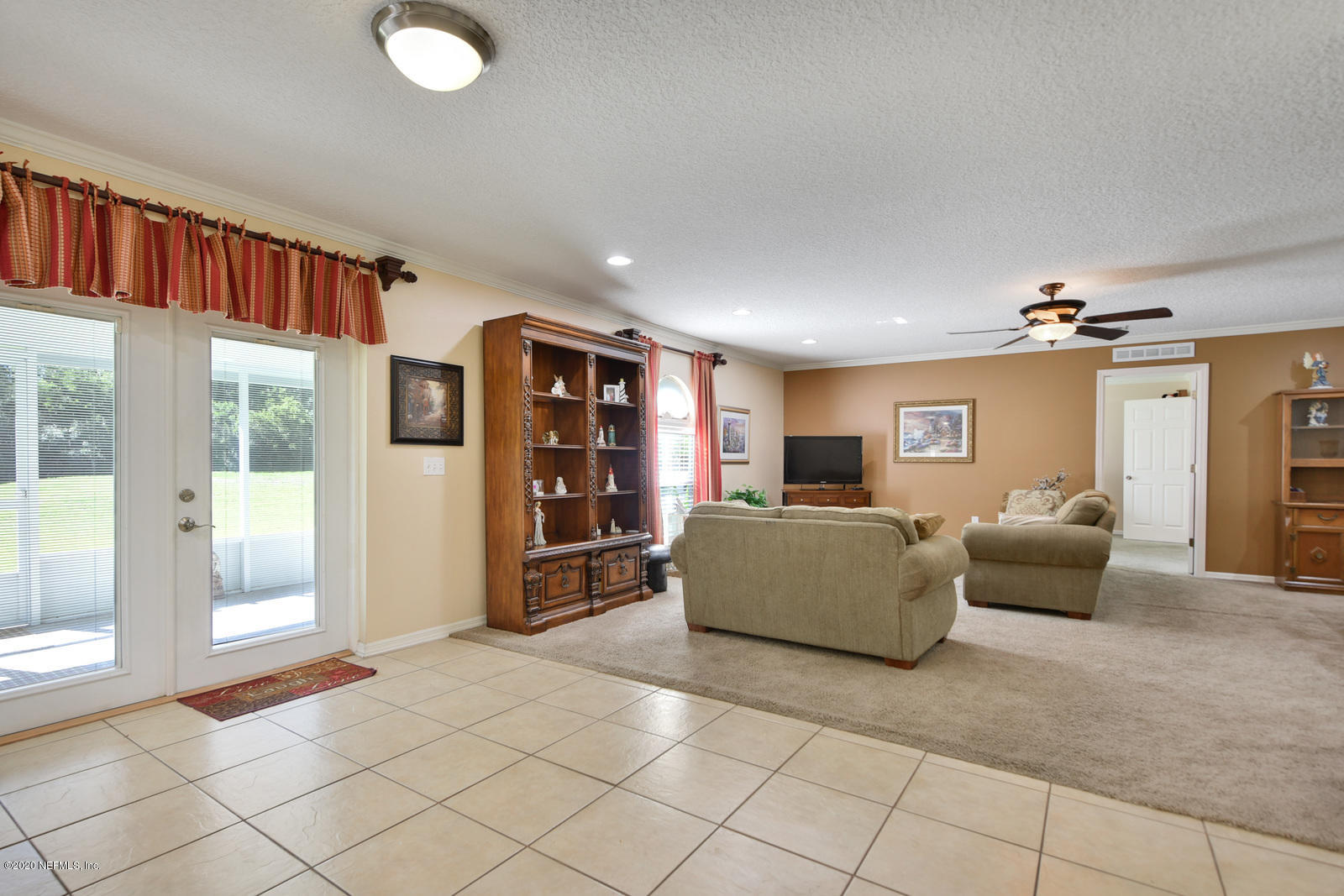 55371 Bear Run Road Callahan, FL 32011 - Photo 10 of 29 a living room with furniture and a floor to ceiling window
