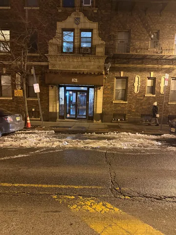 a front view of a building with a yard