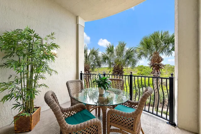 a view of a balcony with furniture and a potted plant