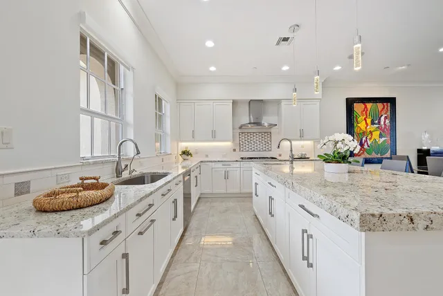 a large kitchen with stainless steel appliances lots of counter space and a sink
