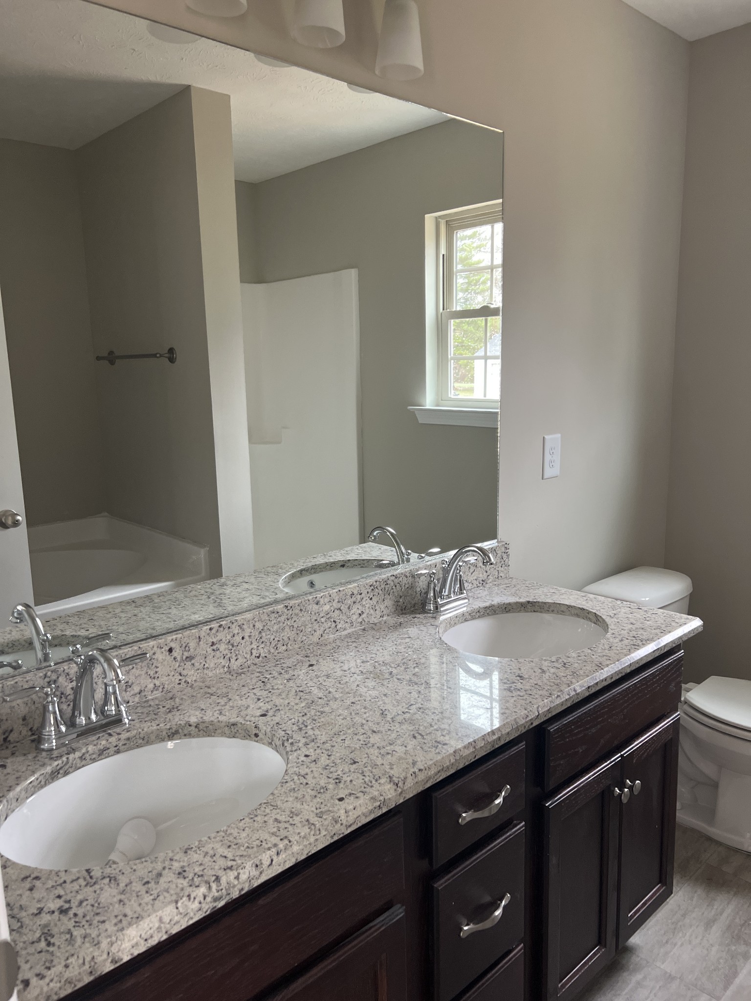 219 Timber Circle Manchester, TN 37355 - Photo 8 of 8 a bathroom with a granite countertop sink and a mirror