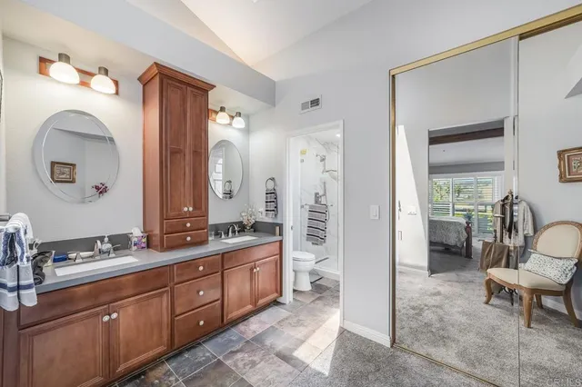 a spacious bathroom with a double vanity sink and a mirror