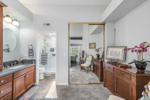 a kitchen with stainless steel appliances kitchen island granite countertop a stove a sink and a refrigerator