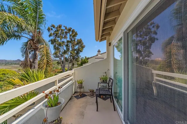 a view of a balcony with potted plants
