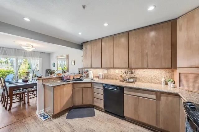 a kitchen with a sink window and cabinets