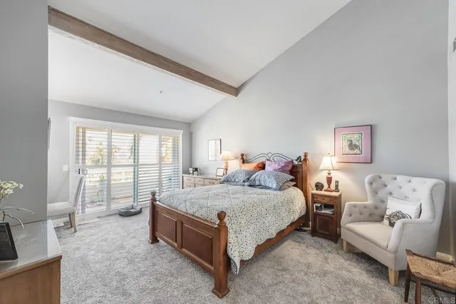 a spacious bedroom with a bed and glass window