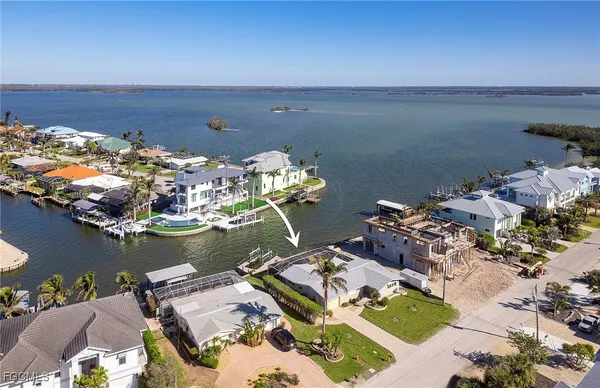 an aerial view of a house with a lake view
