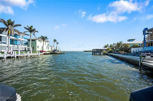 a kitchen with a sink white cabinets and white appliances