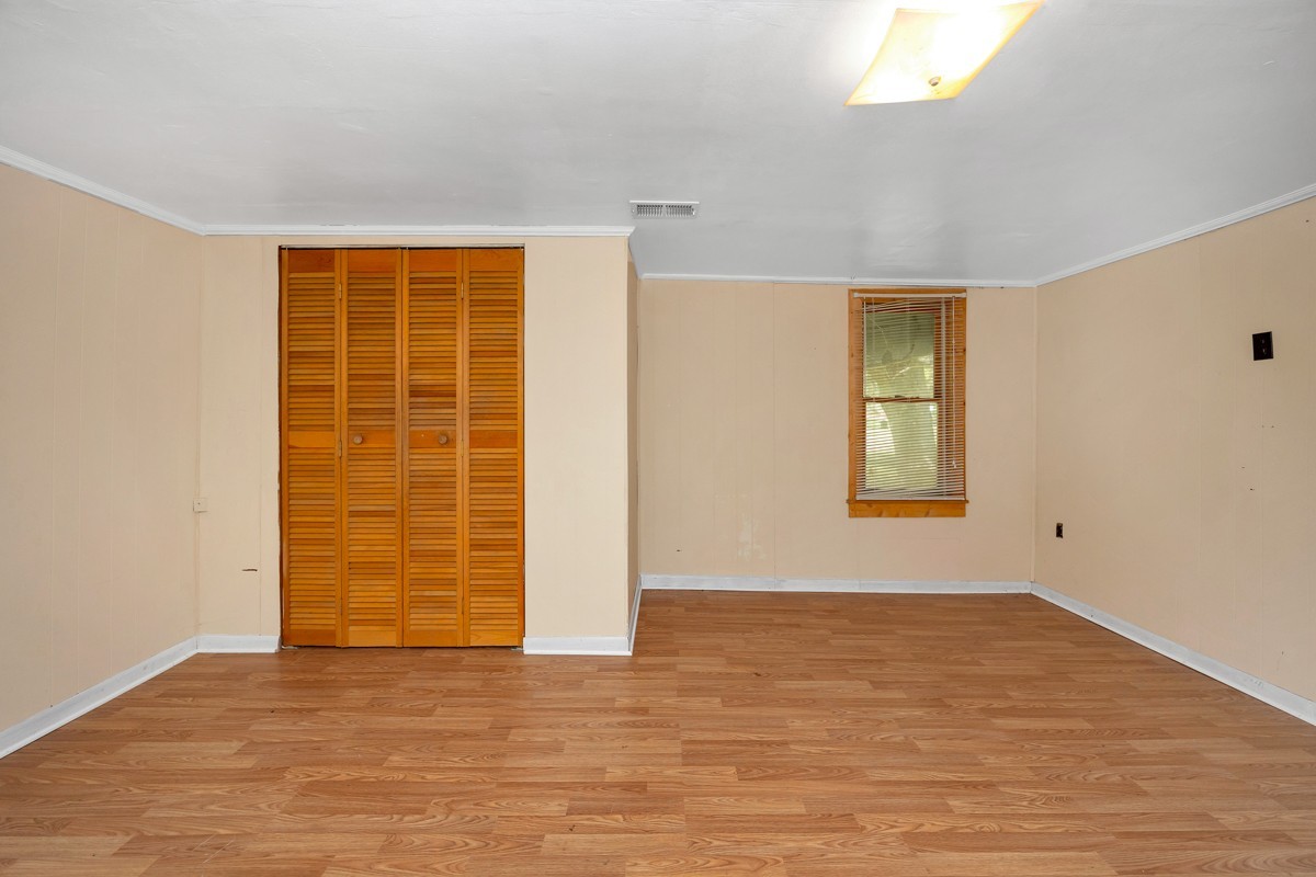 1121 Rolin Hollow Road Ardmore, TN 38449 - Photo 12 of 46 a view of an empty room with wooden floor and a window