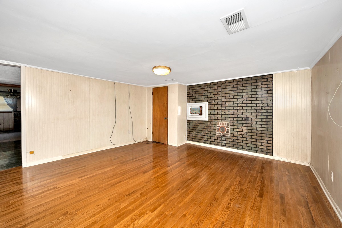 1121 Rolin Hollow Road Ardmore, TN 38449 - Photo 5 of 46 a view of an empty room with wooden floor and a window
