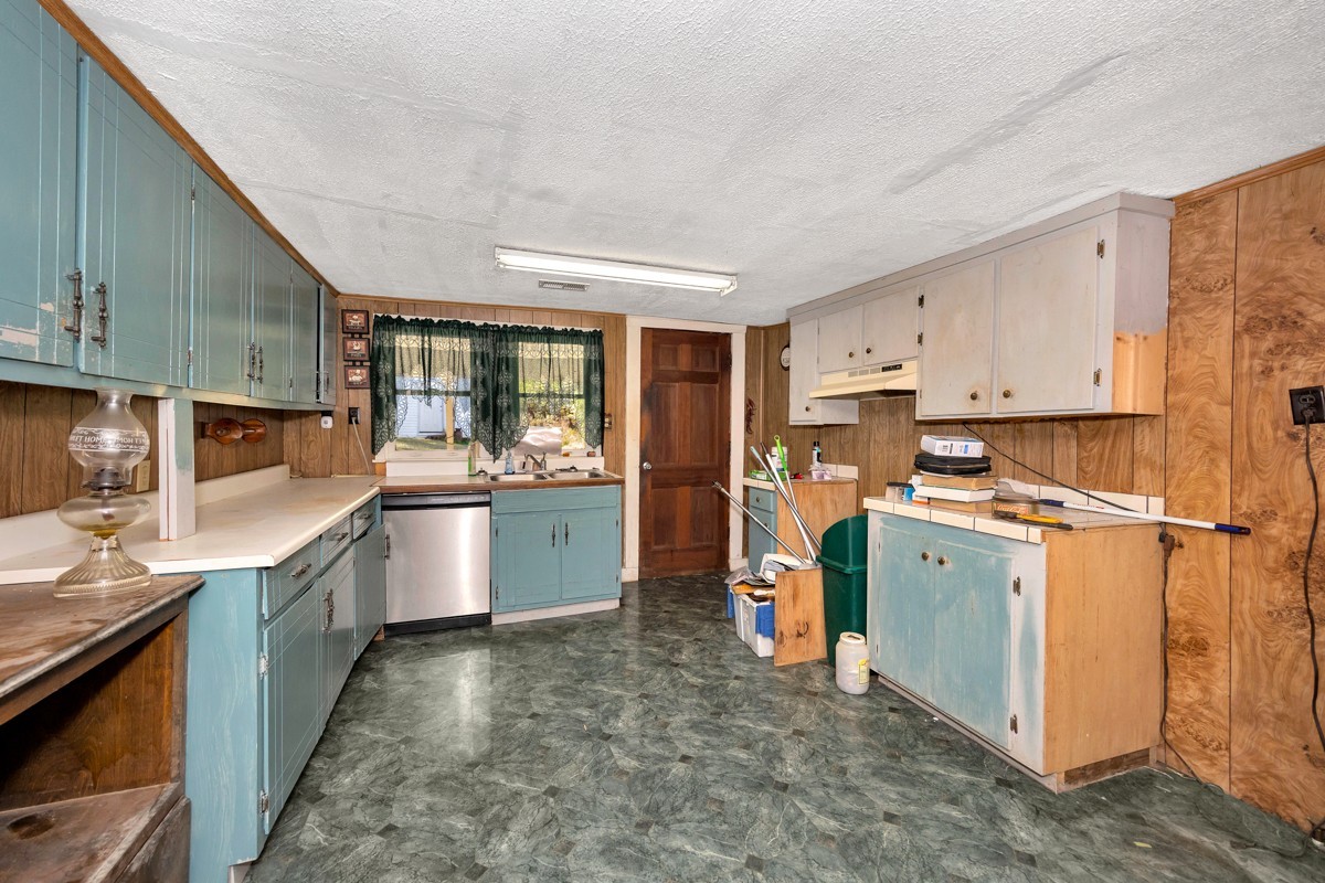 1121 Rolin Hollow Road Ardmore, TN 38449 - Photo 8 of 46 a kitchen with stainless steel appliances granite countertop a sink a stove and a refrigerator