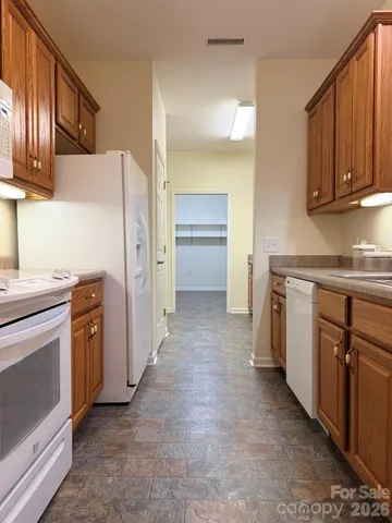 a kitchen with stainless steel appliances granite countertop a sink and a stove top oven