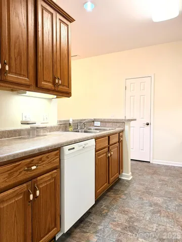 a kitchen with stainless steel appliances a stove a refrigerator and cabinets