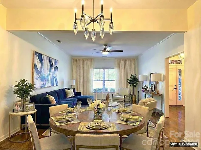 a kitchen with stainless steel appliances granite countertop a refrigerator a stove top oven and a sink with large window