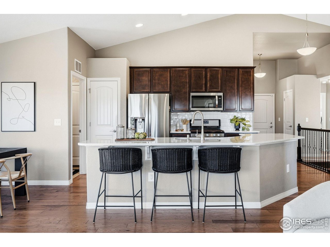 551 Capitol Reef Court Berthoud, CO 80513 - Photo 10 of 42 Large Quartz island for plenty of counter space and additional seating.