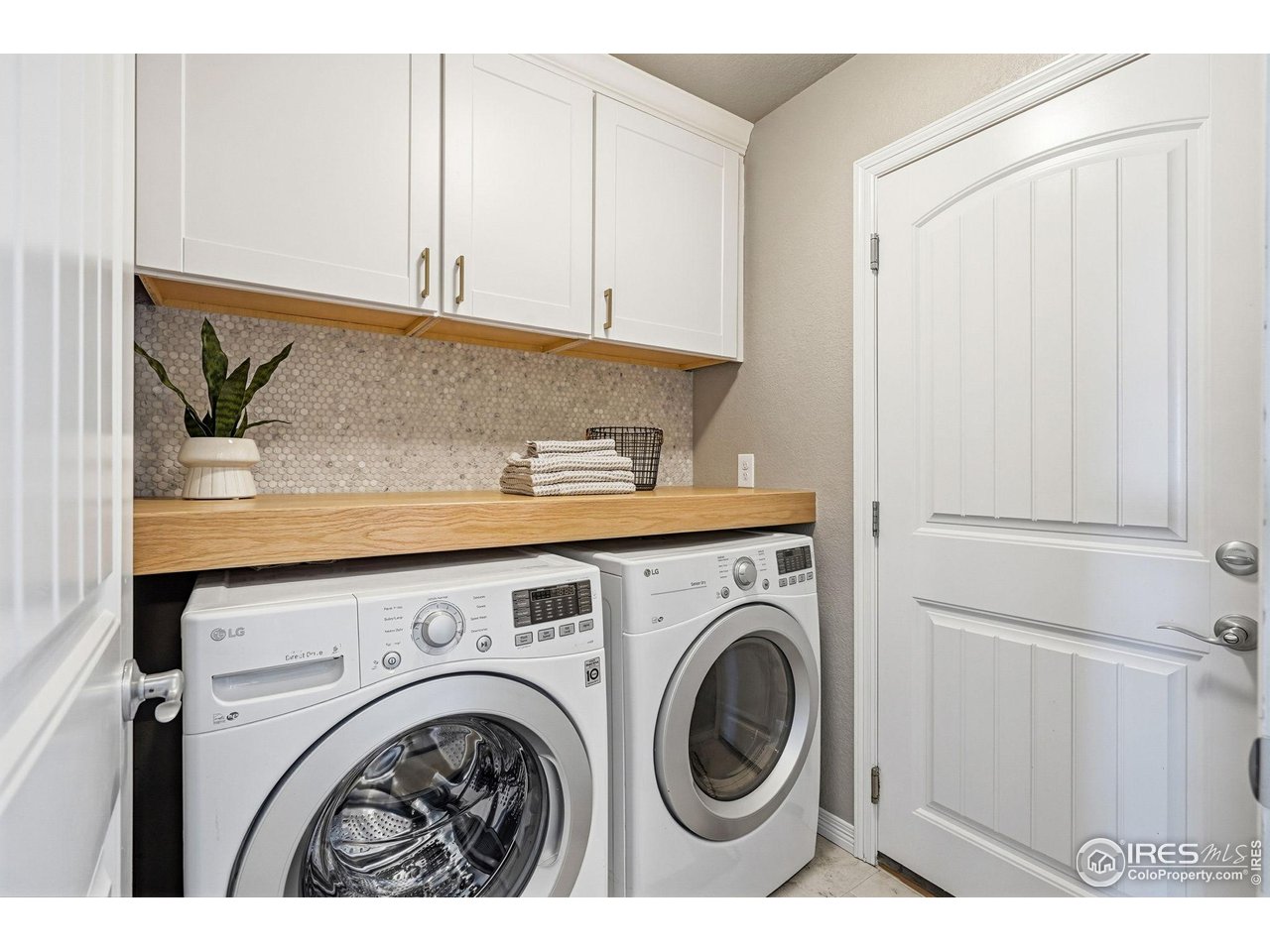 551 Capitol Reef Court Berthoud, CO 80513 - Photo 14 of 42 The beautifully updated laundry room is immediately off the garage making for a perfect "drop zone" before entering the heart of the home