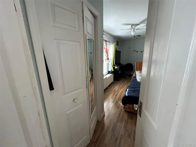 a view of a hallway and a livingroom with furniture