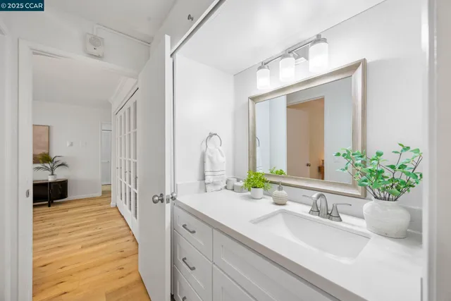 a spacious bathroom with a granite countertop sink and a mirror