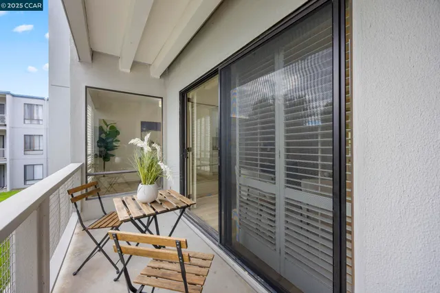 a view of a balcony with furniture