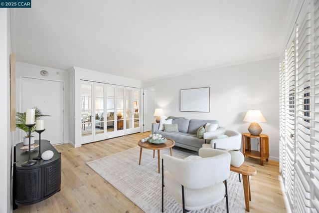 a living room with furniture a chandelier and a window