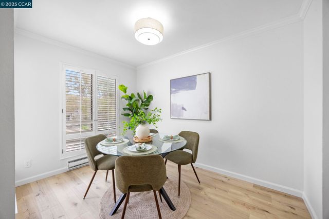 a view of a dining room with furniture and window