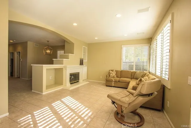a living room with furniture a fireplace and a table