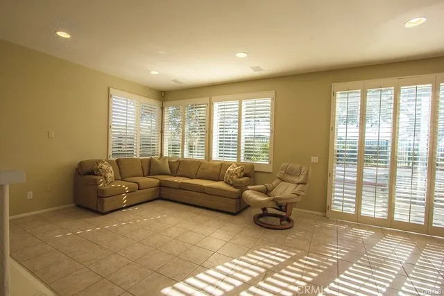 a living room with furniture and a floor to ceiling window