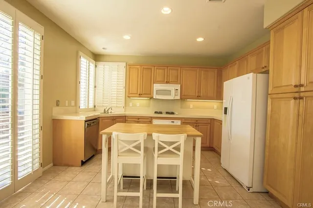 a kitchen with a refrigerator a sink and cabinets