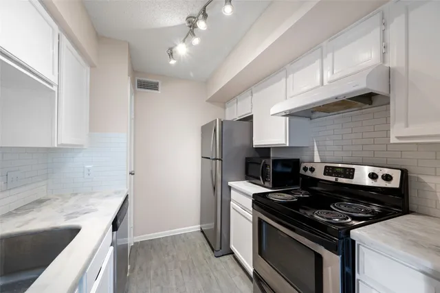 a kitchen with a stove and a refrigerator