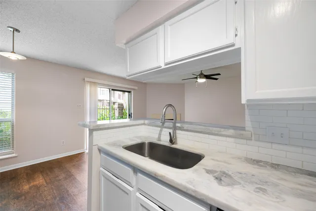 a kitchen with a sink and cabinets