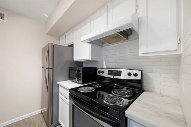 a kitchen with a stove and a refrigerator