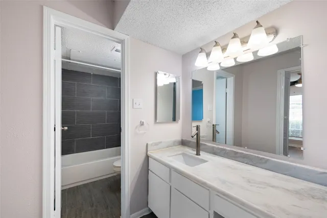 a bathroom with a sink vanity and mirror