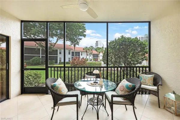 a view of a porch with furniture and wooden floor