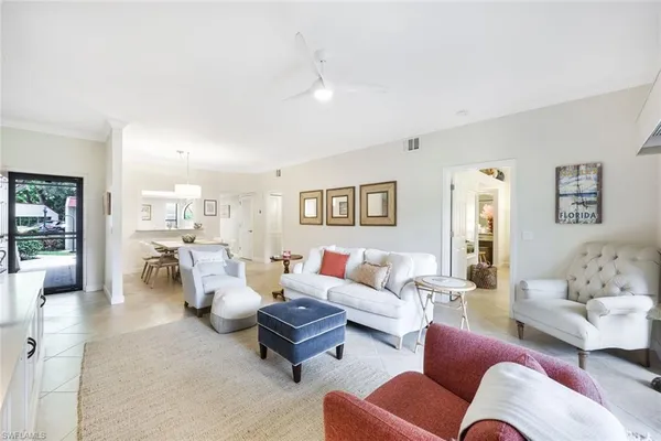 a living room with furniture and view of kitchen