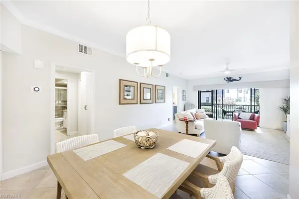 a view of a dining room with furniture and chandelier