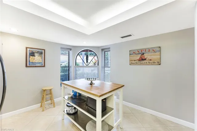 a kitchen with stainless steel appliances granite countertop a refrigerator a stove and a sink with wooden floor