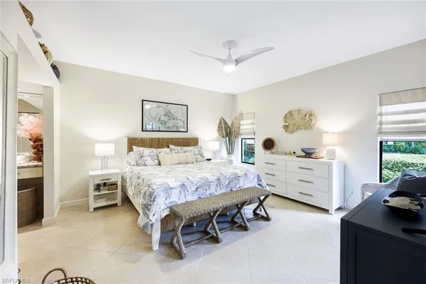 a bathroom with a granite countertop toilet sink and mirror