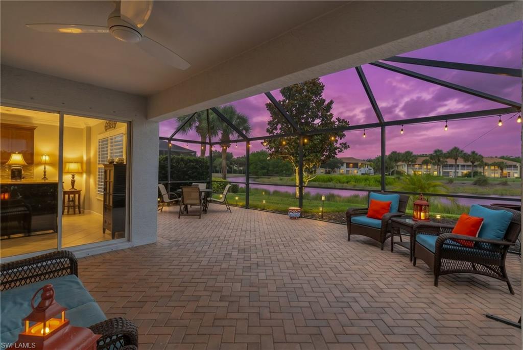 5801 Declaration Court Ave Maria, FL 34142 - Photo 26 of 38 a view of a patio with table and chairs under an umbrella