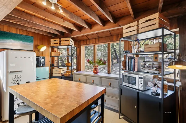 a kitchen with a stove a sink and a dining table