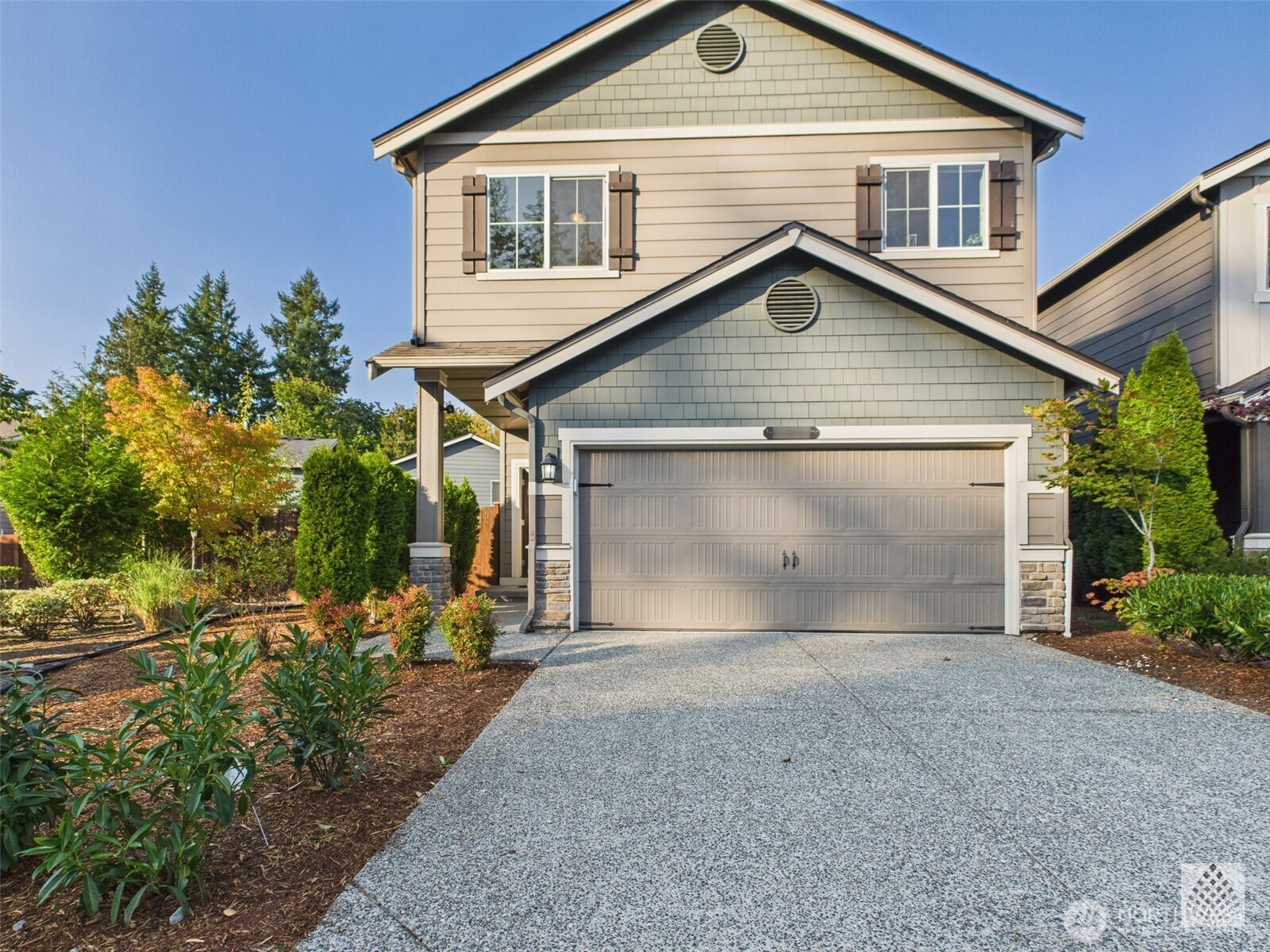 a view of a house with a yard and garage