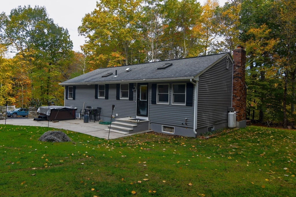 85 Paddock Road Rutland, MA 01543 - Photo 2 of 42 a view of a house with a backyard and sitting area