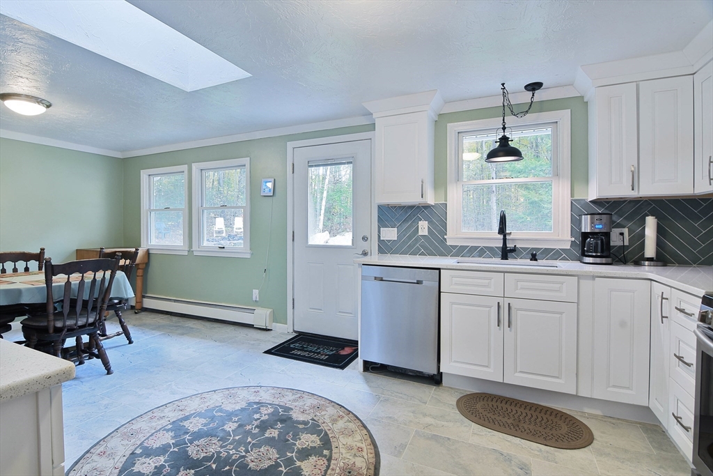 85 Paddock Road Rutland, MA 01543 - Photo 8 of 42 a kitchen with granite countertop a sink cabinets and wooden floor