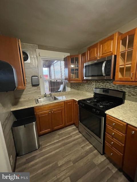 4104 North I Street Philadelphia, PA 19124 - Photo 6 of 16 a kitchen with stainless steel appliances granite countertop a stove a sink and a microwave