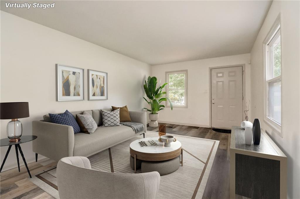 3618 Barrow Place Southwest Atlanta, GA 30331 - Photo 1 of 1 a living room with furniture and a dining table